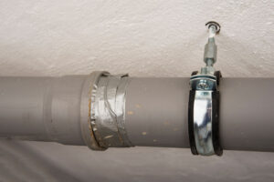 Leaking sewage plastic pipe fixed with a duct tape