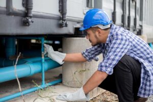 personnel checking water line materials